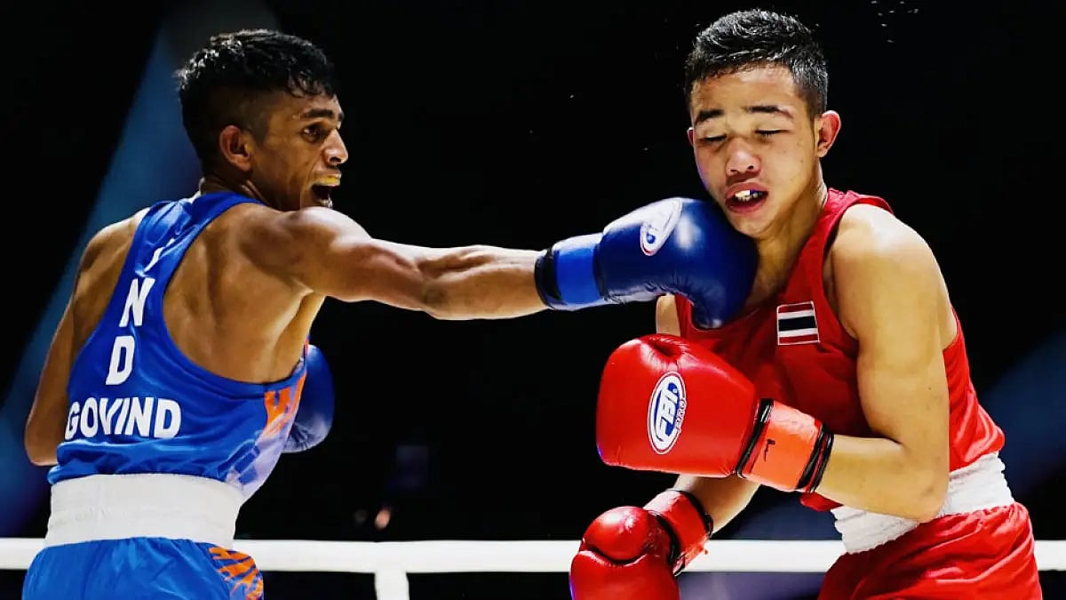 Govind Sahani lands a punch against Natthaphon Thuamcharoen of Thailand.