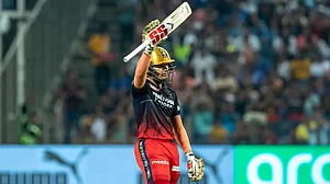 Anuj Rawat raises his bat after completing his fifty against Mumbai Indians in IPL 2022 on Saturday.