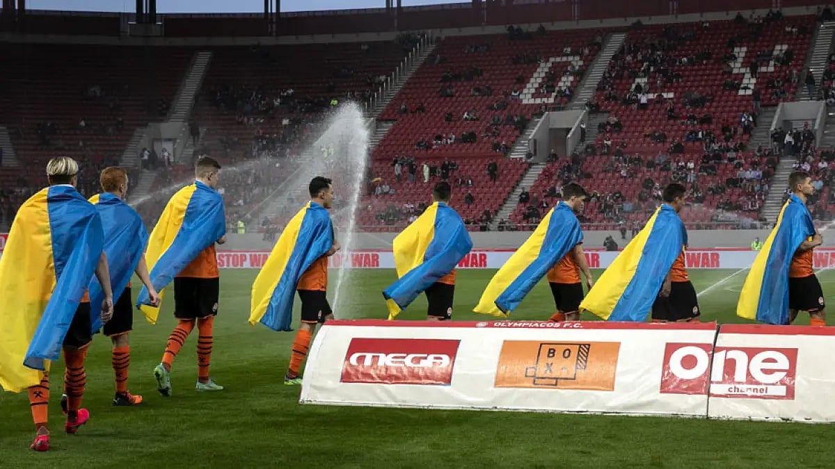 Players of Shakhtar Donetsk enter the pitch ahead of a friendly charity soccer match against Olympiakos at Karaiskaki stadium in Piraeus, near Athens, on Saturday, April 9, 2022.