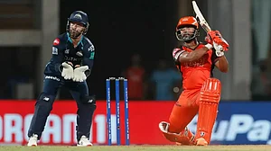 SRH's Rahul Tripathi hits a six as Gujarat Titans 'keeper Matthew Wade looks on in IPL 2022.