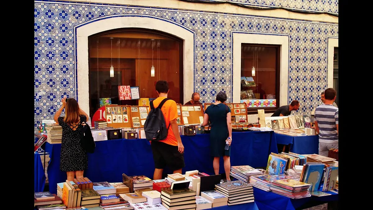 People looking at books outside Livrería Bertram in Lisbon