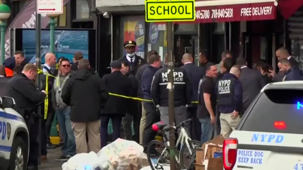 image provided by WABC shows law enforcement gathering at the scene of a shooting in the Brooklyn