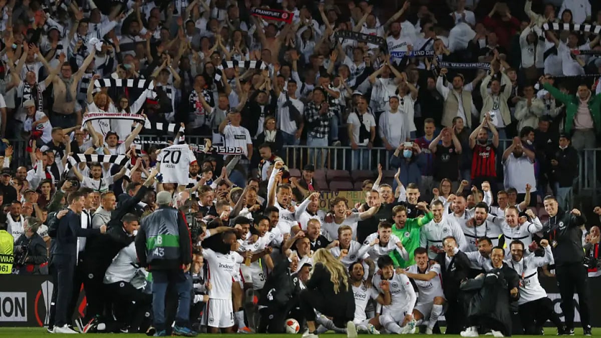 Eintracht Frankfurt players celebrate with fans after beating Barcelona in their Europa League match at Camp Nou stadium, in Barcelona.