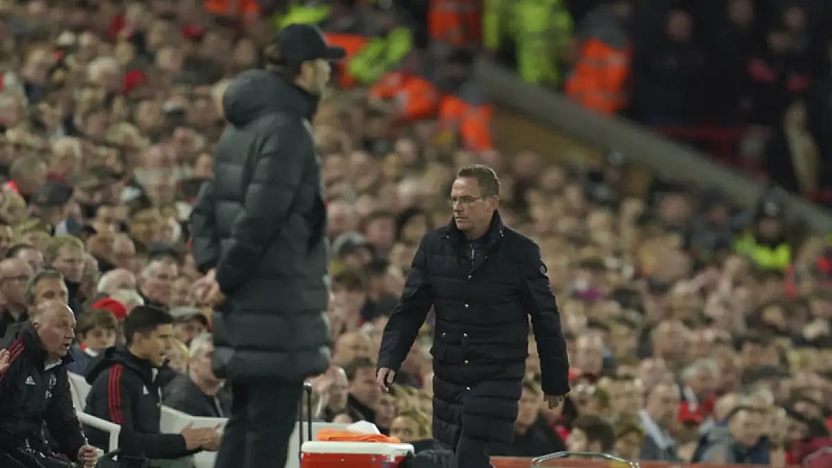 Manchester United's interim manager Ralf Rangnick, right, walks past Liverpool boss Jurgen Klopp at Anfield stadium.