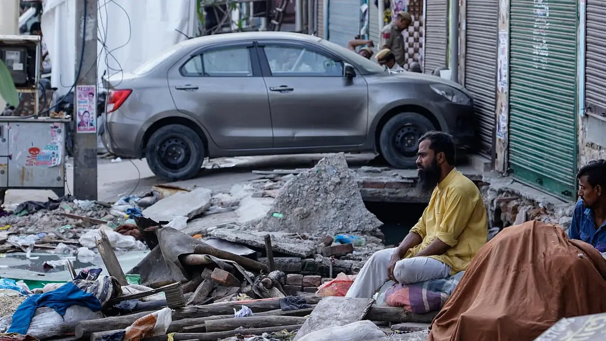 Jahangirpuri residents sitting in front of demolished shops. 
