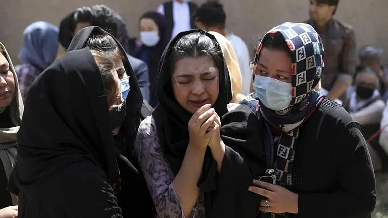 Afghan Hazaras attend the funeral of Mina Khiari, who was killed in a bombing in Kabul in 2021. - null