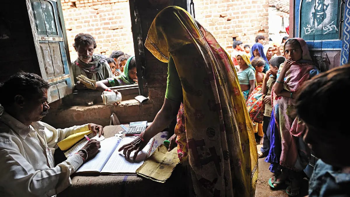People line up outside a fair price shop to receive portions of wheat and rice from the government