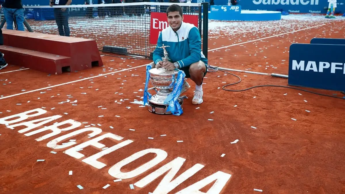 Carlos Alcaraz poses with a trophy after winning the Barcelona Open 2022.