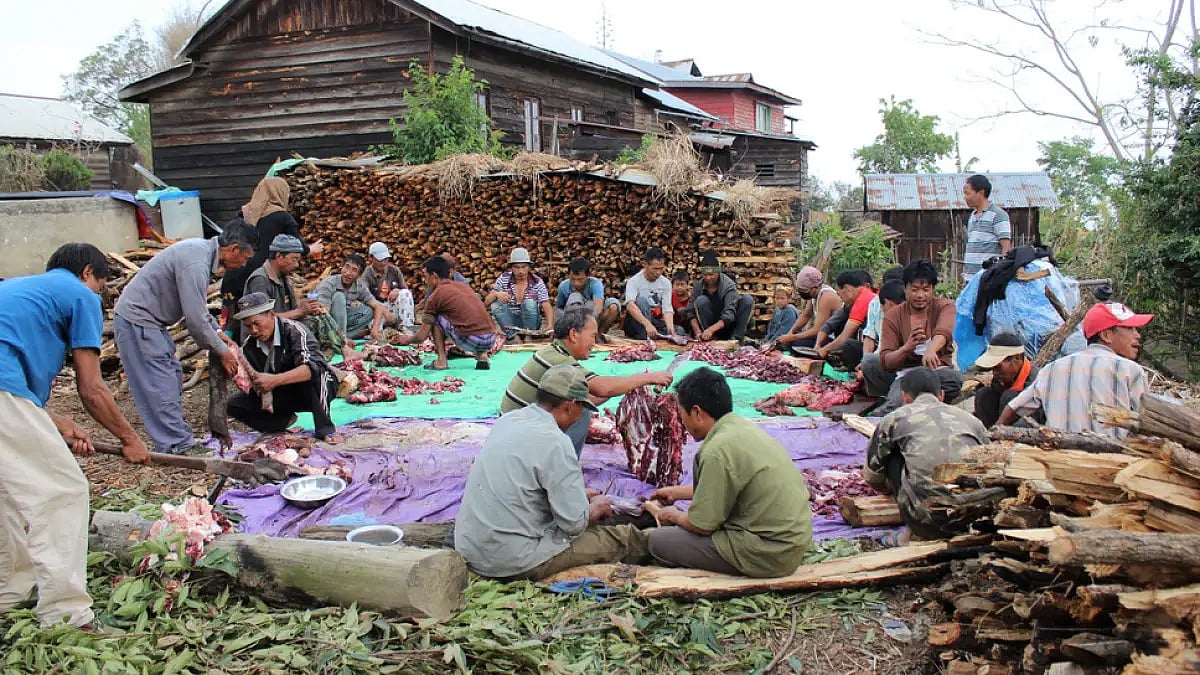 Villagers working together and cooking beef during a wedding party in Ukhrul