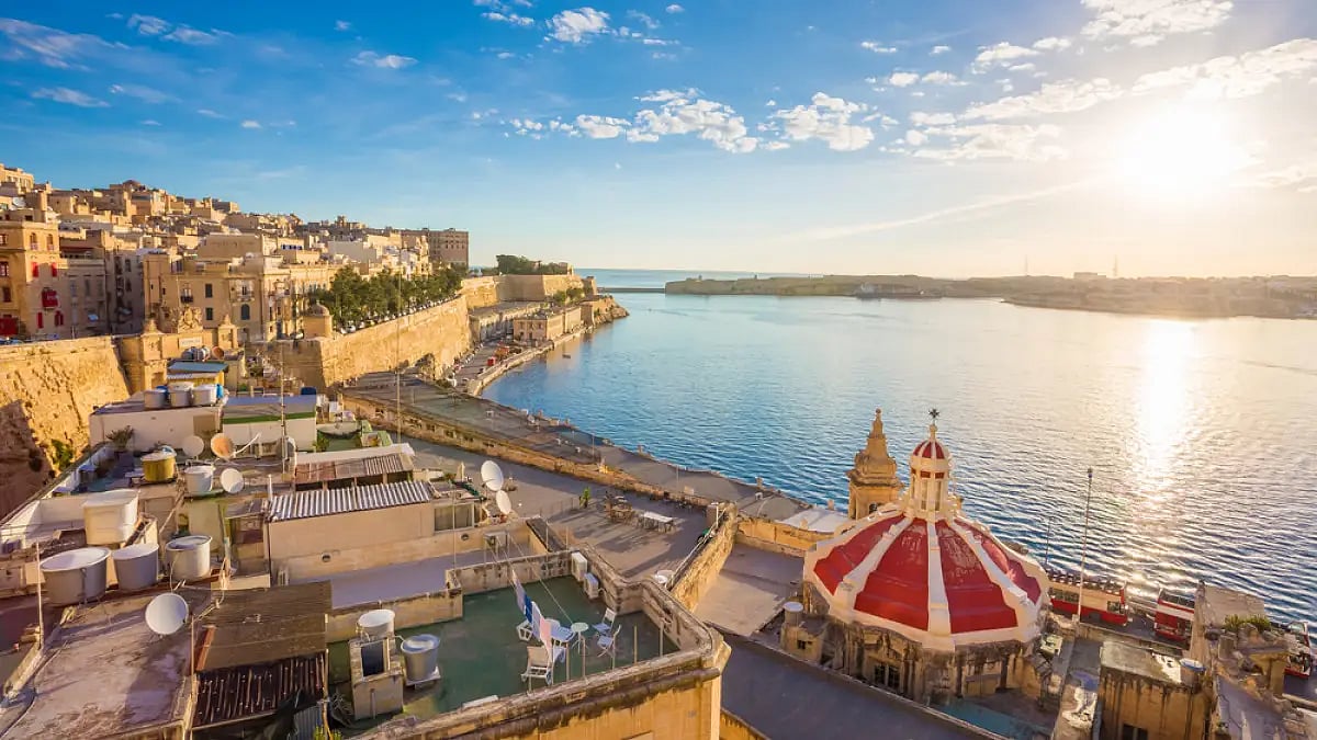 Sunrise at the Grand Harbour of Malta with the ancient walls of Valletta in the foreground