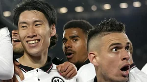 Eintracht Frankfurt's Daichi Kamada, left, celebrates with teammates after scoring a goal against We