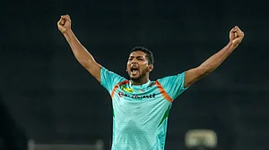 Mohsin Khan celebrates after taking one of his three wickets against Punjab Kings in IPL 2022.