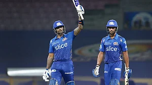 Suryakumar Yadav raises his bat after his fifty against Rajasthan Royals in an IPL 2022 game.