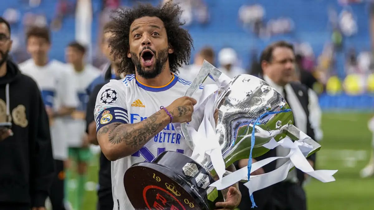 Real Madrid's Marcelo poses with the trophy to celebrate the team's La Liga title at the Santiago Be