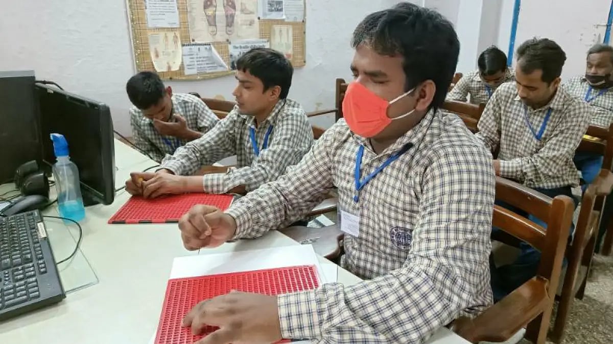 Visually impaired students learning Braille.