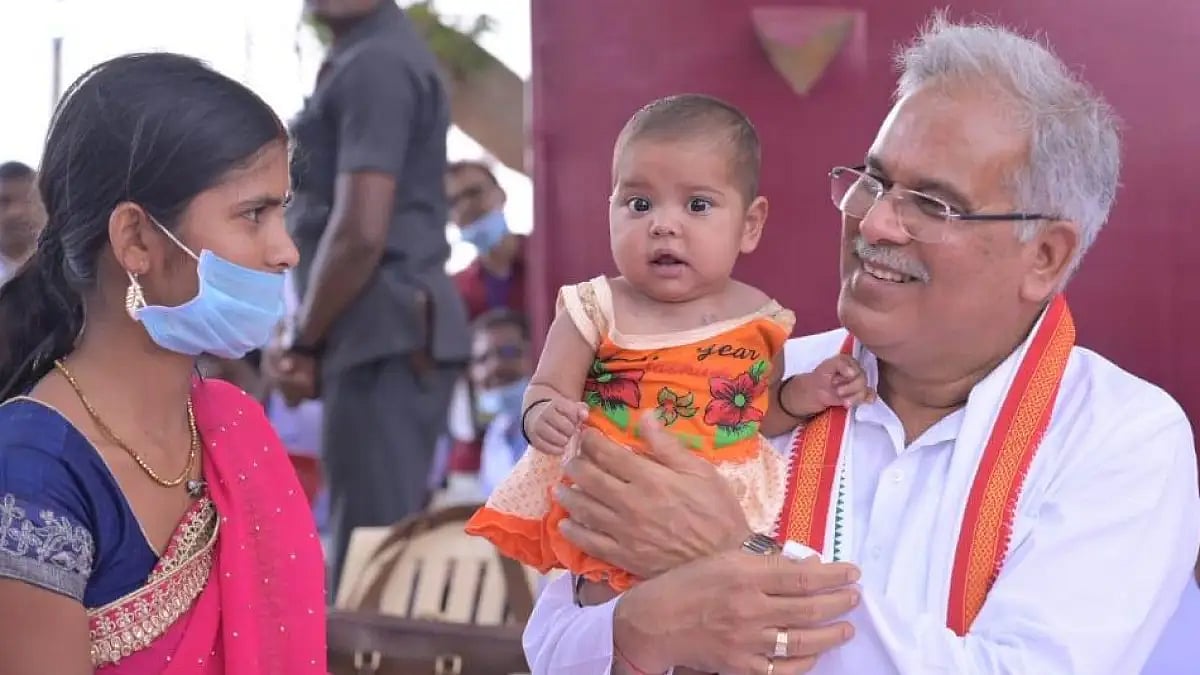 Chhattisgarh CM Bhupesh Baghel interacting with a woman and child in Kusumi