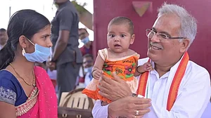 Chhattisgarh CM Bhupesh Baghel interacting with a woman and child in Kusumi