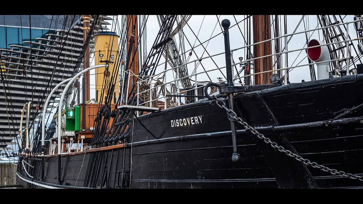 The RRS Discovery wooden auxiliary steamship used by Shackleton and Scott in the Antarctic next to t