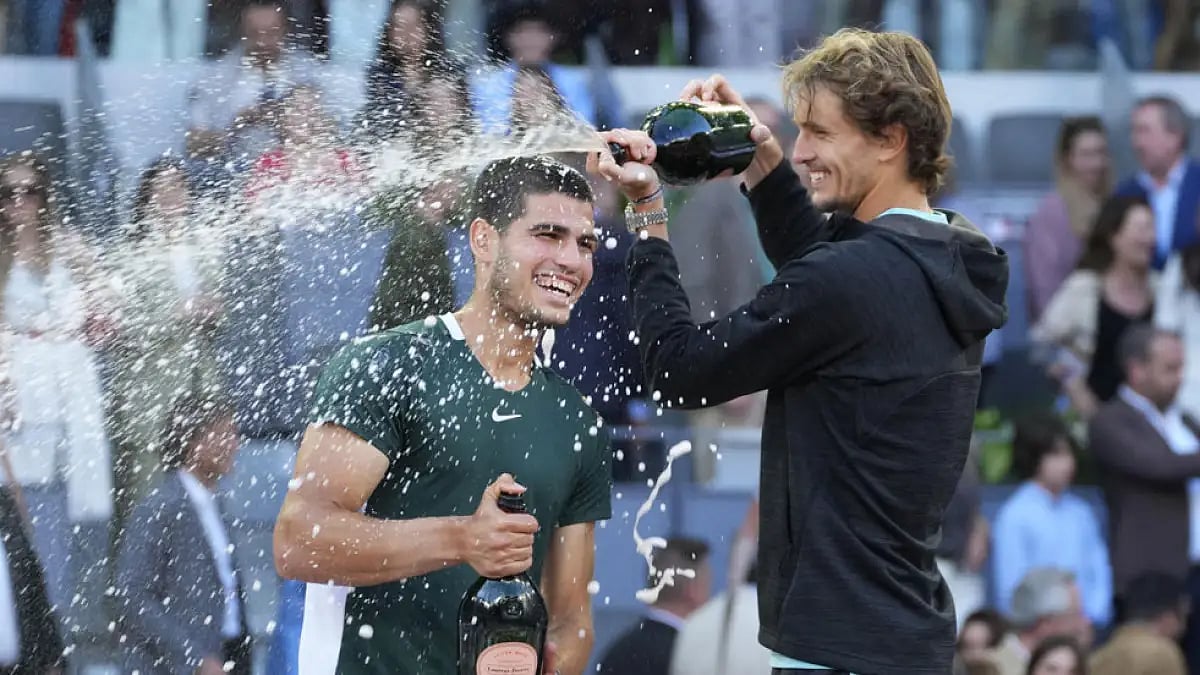 Carlos Alcaraz and Alexander Zverev celebrate after the end of Madrid Open final on May 8, 2022.