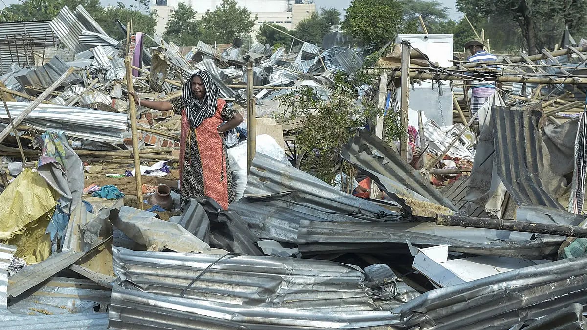 Residents of the slums in Saraswati Kunj, Gurugram collect their belongings and prepare to move as authorities carried out a demolition drive during Covid-19 pandemic. 