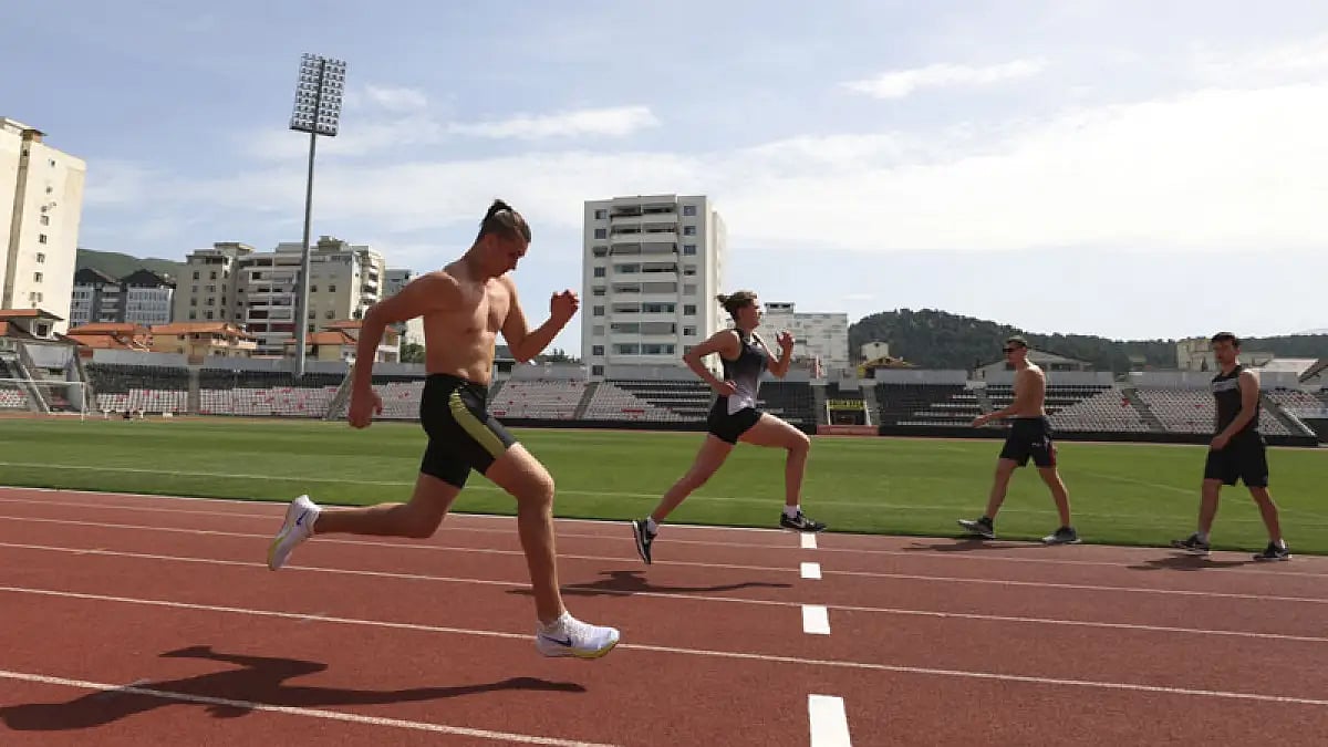 Ukrainian athletes Oleksander Titarenko, left, and Hanna Tkachova practice during a training session at Elbasan Arena stadium in Elbasan, Albania, May 9, 2022.