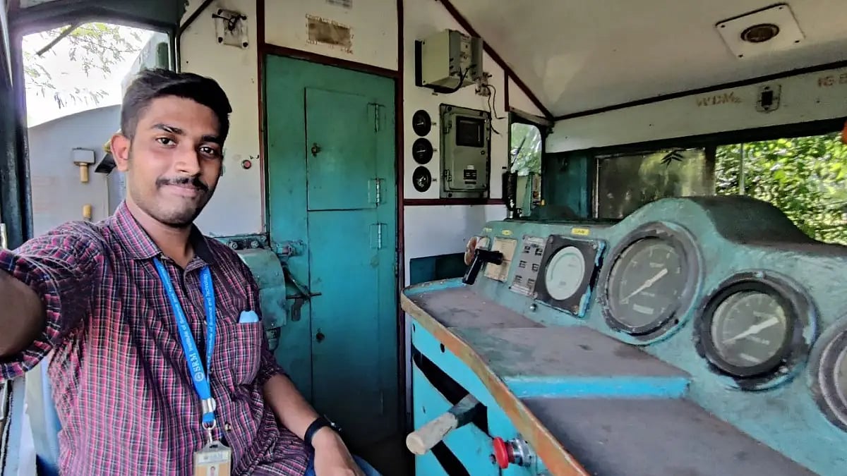 Trainspotter Jerin George inside the driver's cabin of an ALCo WDM2