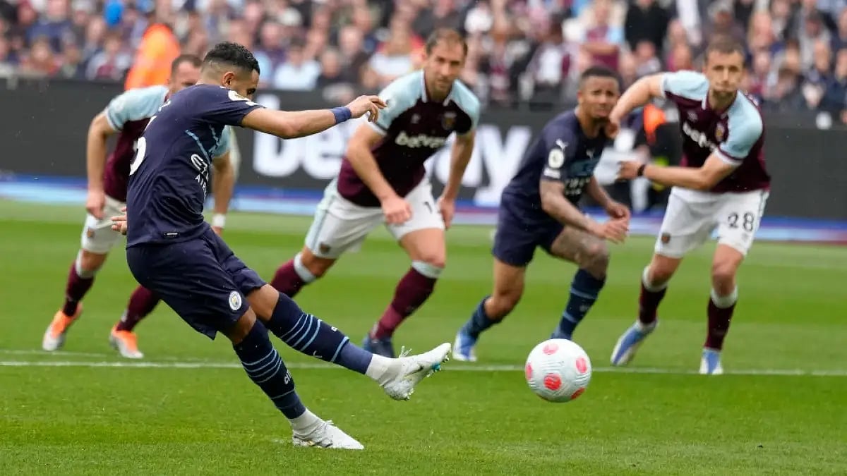Manchester City's Riyad Mahrez takes a penalty against West Ham in a Premier League 2021-22 tie.