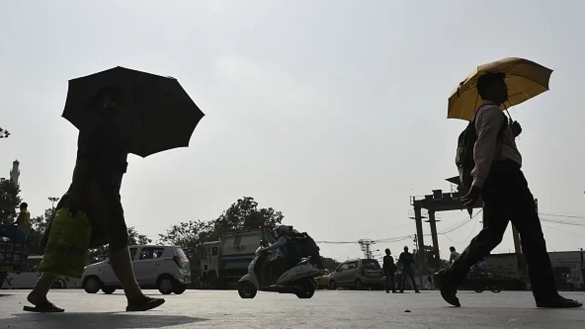 People carry umbrella amid heatwave in Kolkata