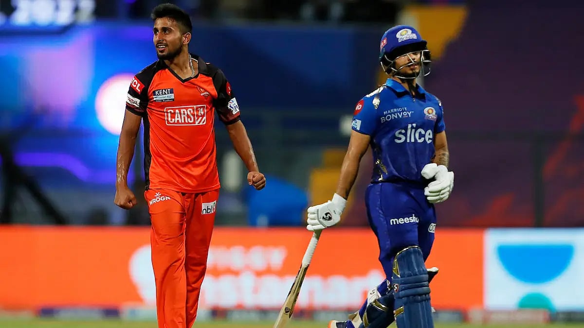 Umran Malik celebrates after dismissing Ishan Kishan in an IPL 2022 match.  