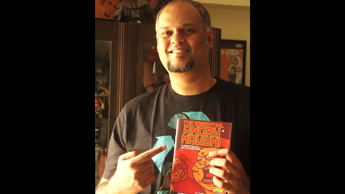 Artist Abhijeet Kini with the Angry Maushi book