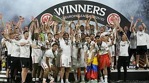 Eintracht Frankfurt players celebrate with the trophy after winning the Europa League final against Rangers FC in Seville, Spain, May 18, 2022.