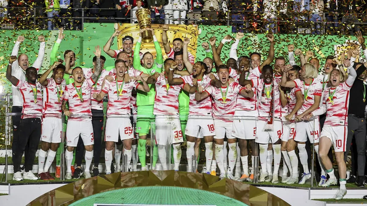 RB Leipzig players celebrate with the German Cup trophy after beating Freiburg in the final.