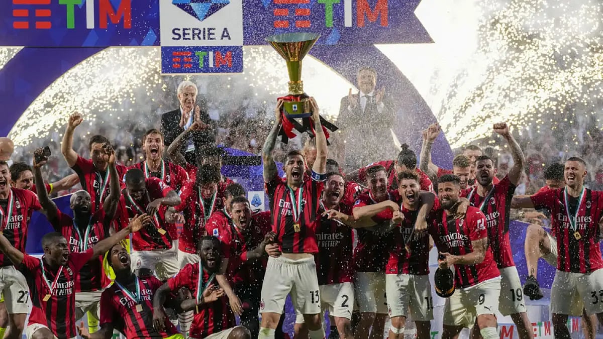 AC Milan players celebrate with Serie A trophy after the end of their match against Sassuolo at the Citta del Tricolore stadium, May 22, 2022.