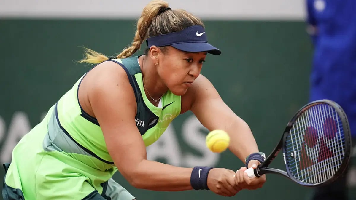 Naomi Osaka returns a shot to Amanda Anisimova during their French Open match on May 23, 2022.