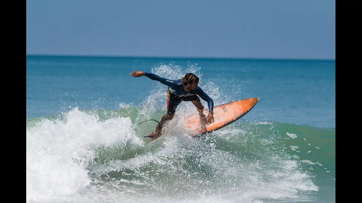 A surfer in action at Varkala Beach in Kerala