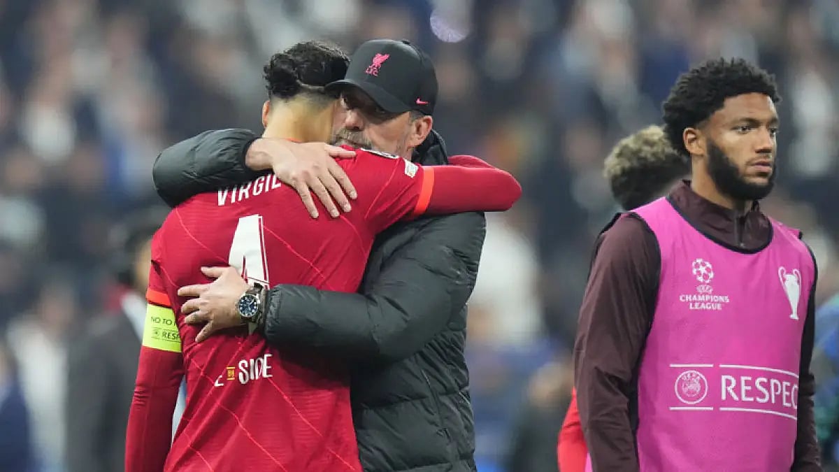 Liverpool's manager Jurgen Klopp embraces Virgil van Dijk after the Champions League final match against Real Madrid at the Stade de France, May 28, 2022.