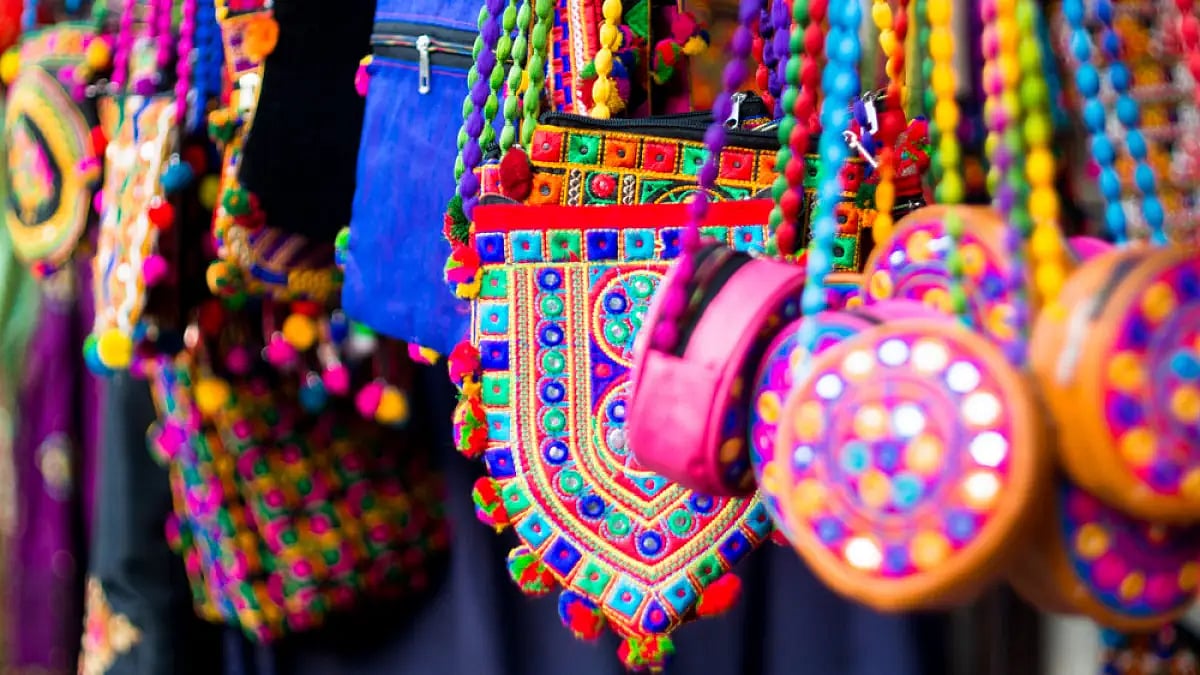Colourful textile handbags hanging in a store in market 