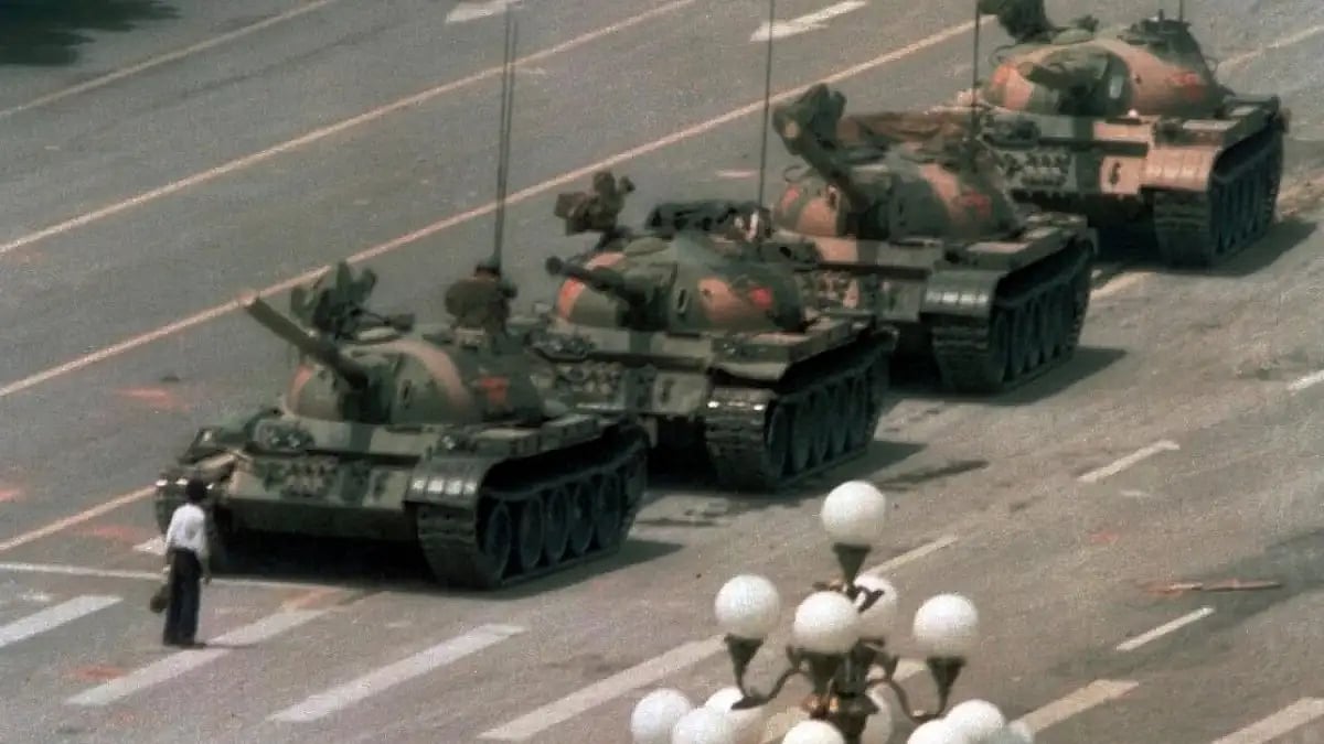 The Tank Man, a Chinese man blocking the path of Chinese tanks after Tiananmen Square Massacre