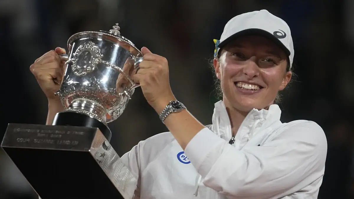 Iga Swiatek holds the trophy after winning the final of women’s singles against Coco Gauff at the Fr