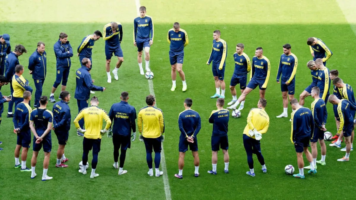 Ukraine players form a circle during a training session at the Cardiff City Stadium.