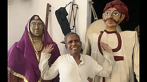 Ramnivas with two life-sized puppets at Barefoot College, Tilonia