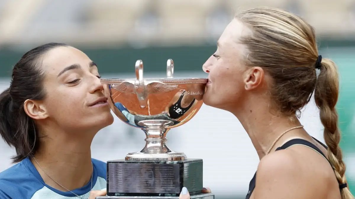 Caroline Garcia (left) and Kristina Mladenovic kiss the cup after winning women doubles final match 