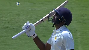 Karnataka's Ravikumar Samarth celebrates after scoring his fifty vs Uttar Pradesh in Ranji Trophy.