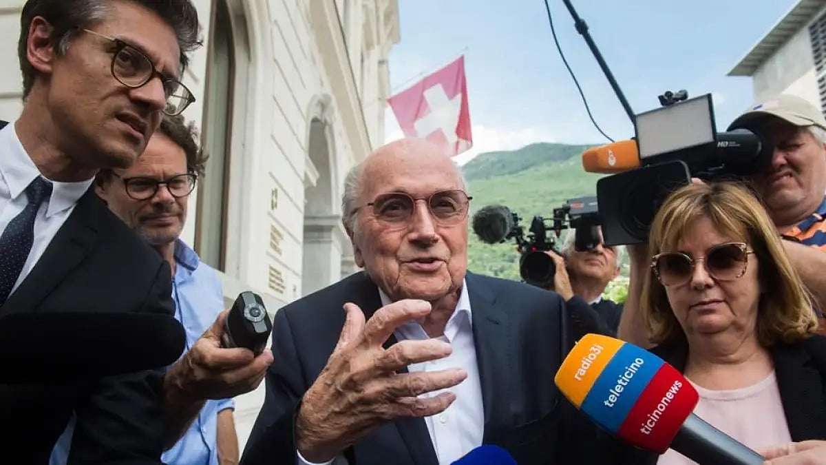 Sepp Blatter is surrounded by the media as he leaves the Swiss Federal Criminal Court in Bellinzona 
