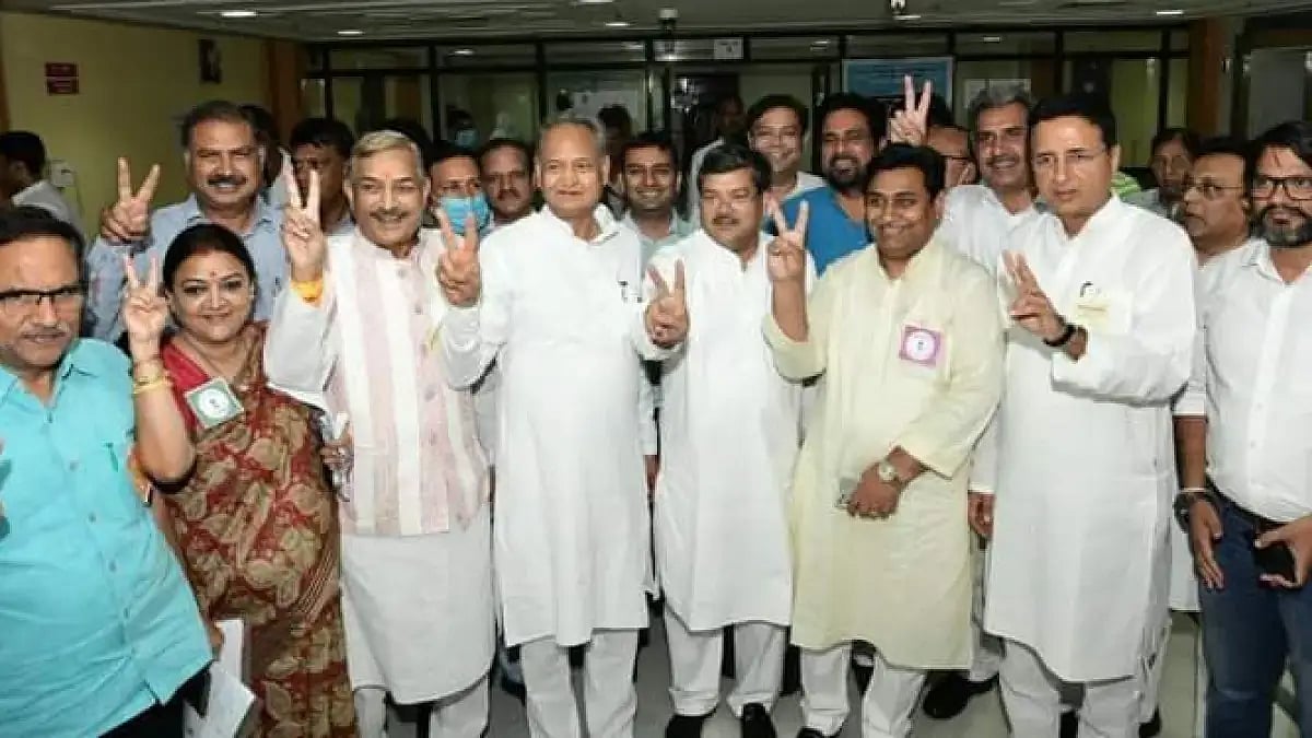 Rajasthan CM Ashok Gehlot flashing the victory sign with tree winning Congress candidates and others