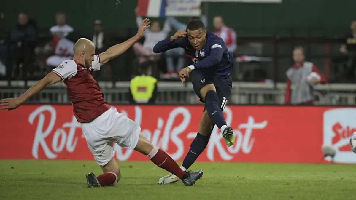 Austria's Gernot Trauner, left, tries to stop France's Kylian Mbappe during their UEFA Nations League match in Vienna, June 10, 2022.