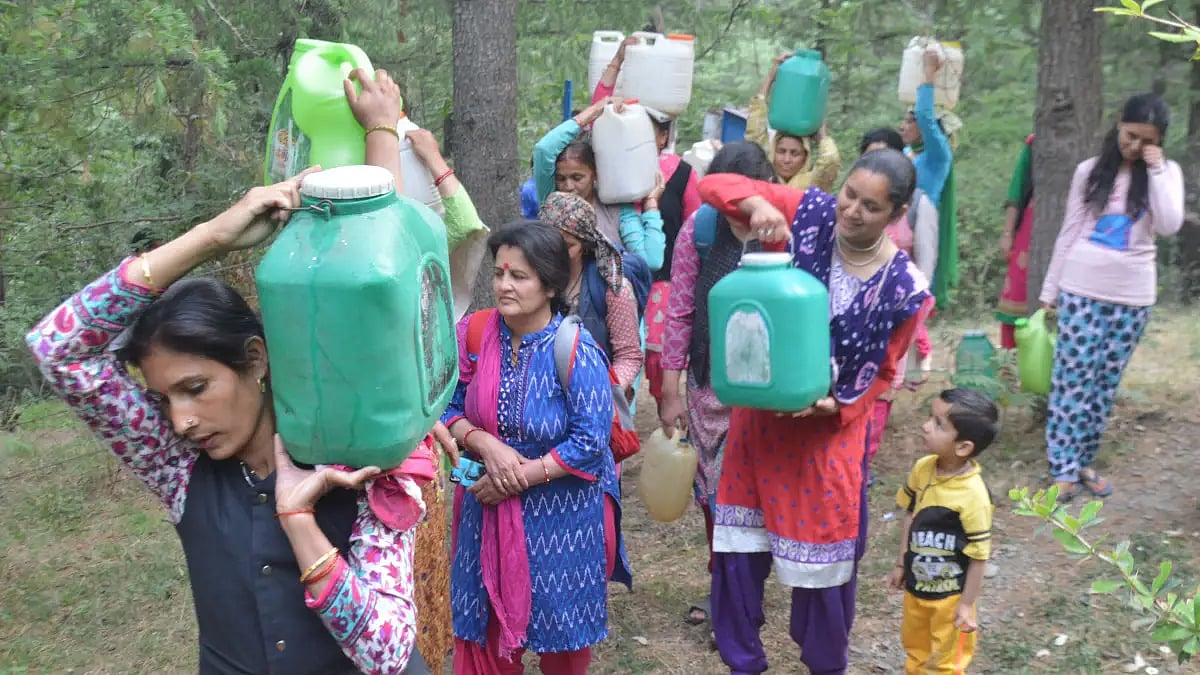 Women carrying pots of water on their shoulders. 