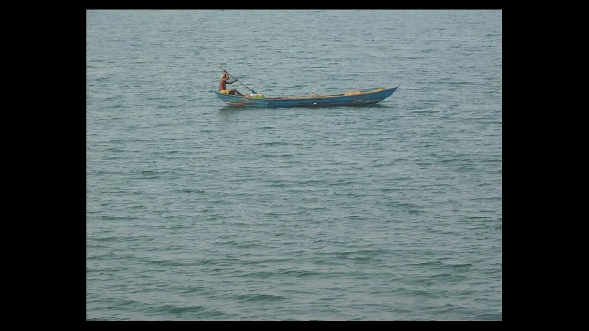 A villager fishing in the dam water
