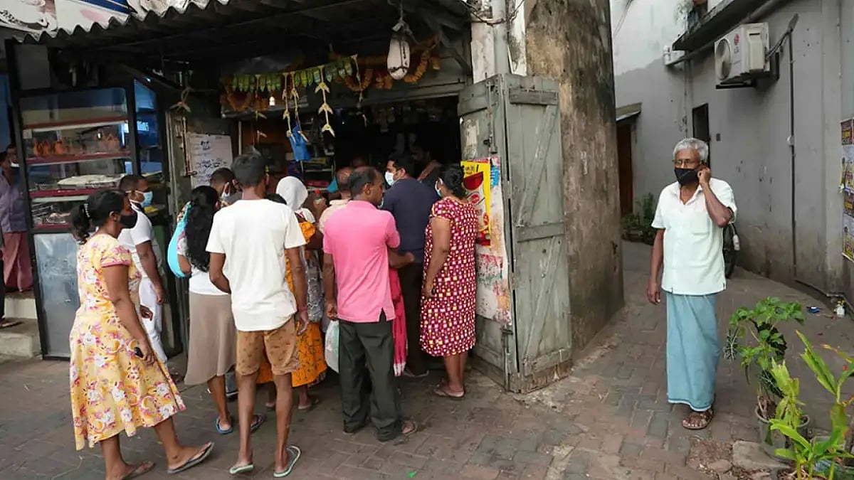 Sri Lankans at a grocery store to stock essentials 