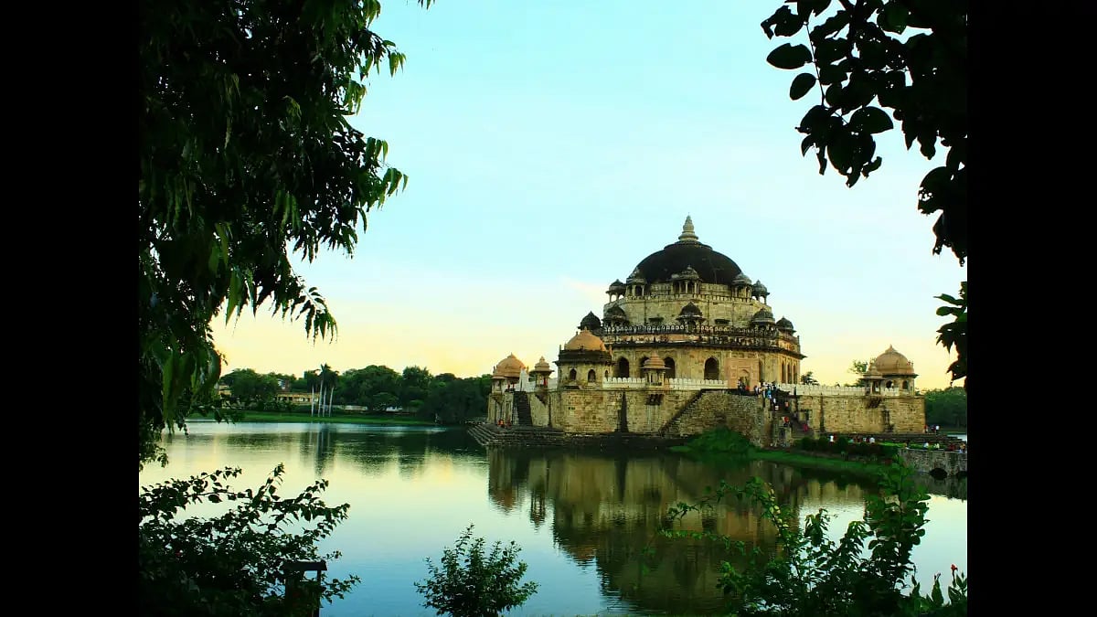 The red sandstone structure stands in the middle of an artificial lake